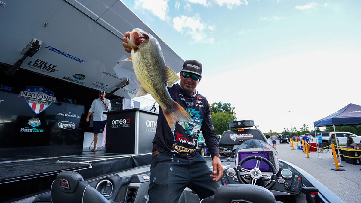 tournament angler holding largemouth bass