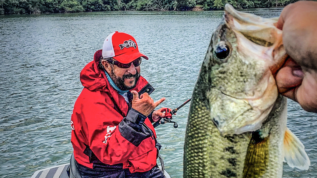 fisherman smiling with bass